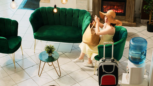 Side view of woman sitting on chair