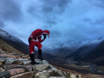 Full length of person on snowcapped mountains against sky