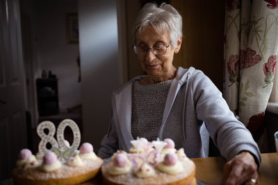 Portrait of young man holding food at home