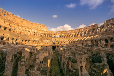 Ruined coliseum against sky