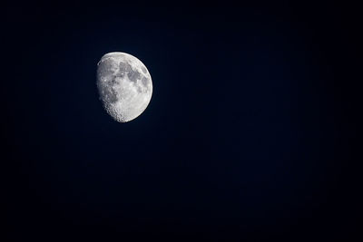 Low angle view of half moon against sky at night