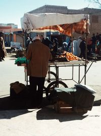 Rear view of people at market stall in city