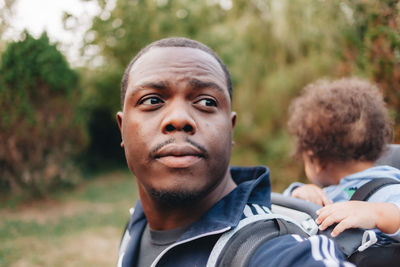 Black father and mixed race son outdoors on a hiking trail