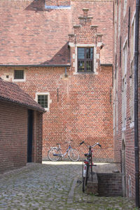 Bicycle on brick wall of building