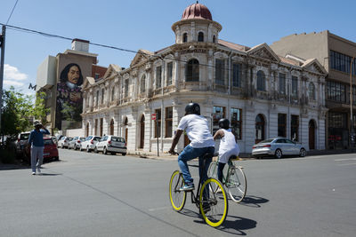 Man riding bicycle on street in city