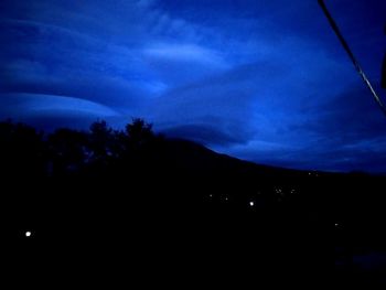 Low angle view of silhouette trees against sky at night