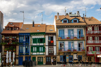 Residential buildings against sky in town