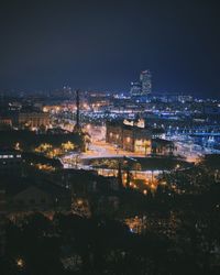 High angle view of illuminated buildings in city at night