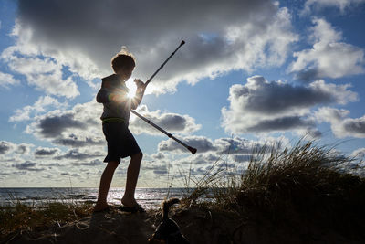 Full length of man standing on beach against sky