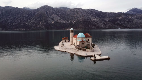 Ship in lake against mountain range