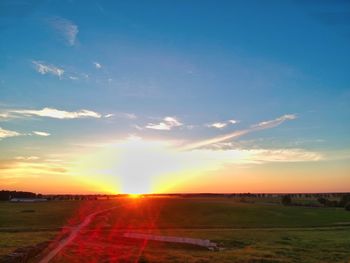 Scenic view of field against sky during sunset