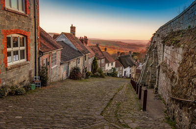 Street amidst buildings against sky