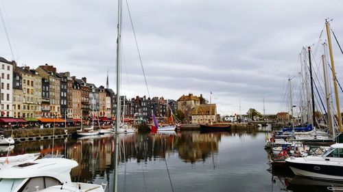 Boats in city against sky