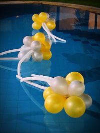 View of yellow balloons in swimming pool