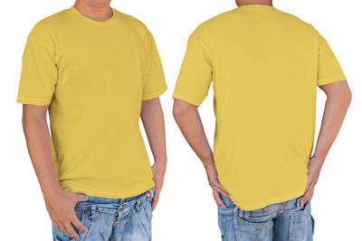 Rear view of man standing against yellow background