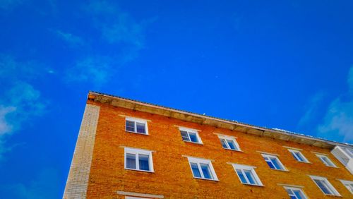 Low angle view of building against blue sky