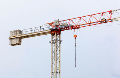 Low angle view of crane against sky