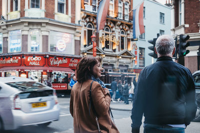 Rear view of people on city street