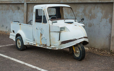 Abandoned vehicle against the wall