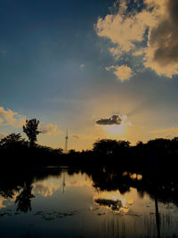 Scenic view of lake against sky during sunset