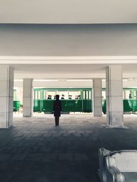 Full length of people walking on tiled floor