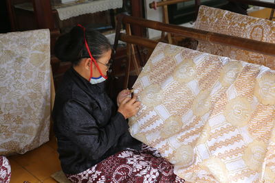 High angle view of woman sitting on seat