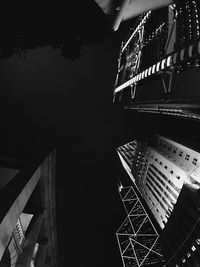 Low angle view of illuminated skyscraper against sky at night