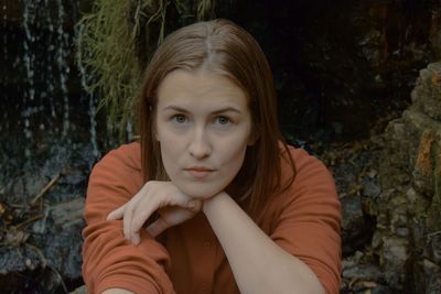 Portrait of a beautiful young woman against trees