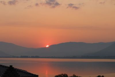 Scenic view of lake against romantic sky at sunset