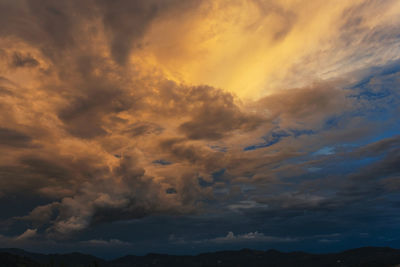 Low angle view of dramatic sky during sunset