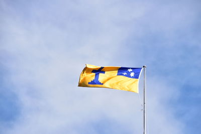 Low angle view of flags flag against sky