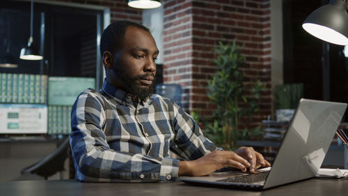 Young man using laptop at table