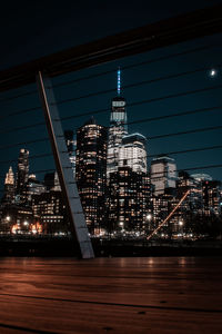 Illuminated buildings against sky at night