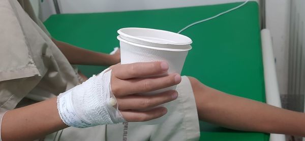 Midsection of woman holding drink