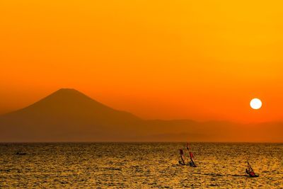 Scenic view of sea against orange sky during sunset