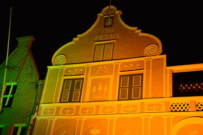 Low angle view of illuminated building against sky