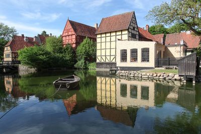 Reflection of building on lake against sky