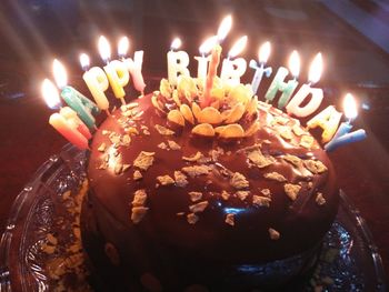 High angle view of lit candles on birthday cake