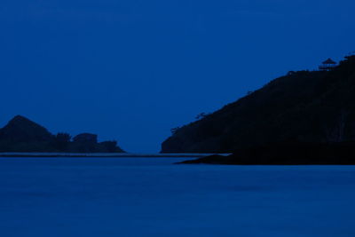 Scenic view of lake against clear blue sky