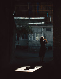 Rear view of man standing in tunnel