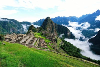 Scenic view of mountains against cloudy sky