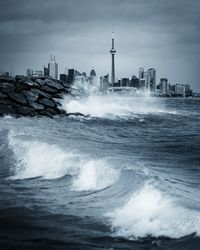 Scenic view of sea and buildings against sky