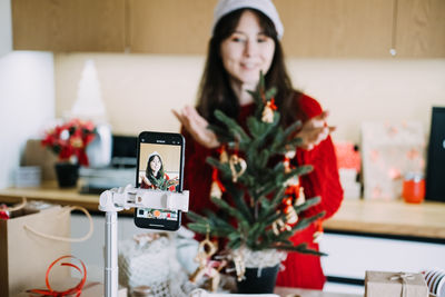 Portrait of young woman sitting on table