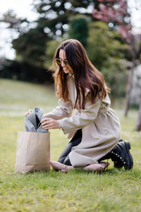 Woman with umbrella on field