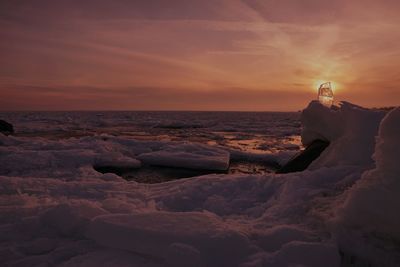 Full length of woman standing at beach against sky during sunset