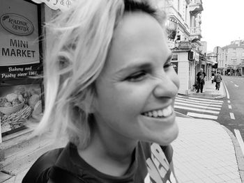 Portrait of smiling woman on street in city