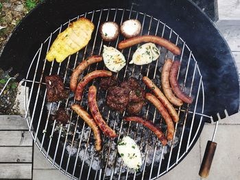 High angle view of meat on barbecue grill
