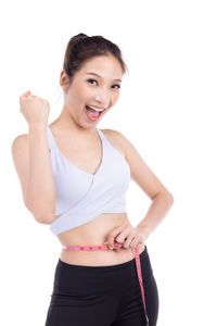 Portrait of a smiling young woman over white background