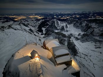 Aerial view of snowcapped mountain against sky during winter