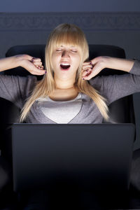 Portrait of a smiling young woman using mobile phone